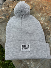 Load image into Gallery viewer, Pom Pom Winter Woven Label Beanie
