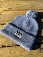 Load image into Gallery viewer, Pom Pom Winter Woven Label Beanie
